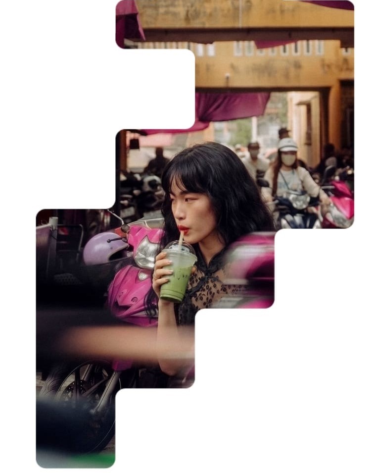 A woman drinking matcha on a busy city street